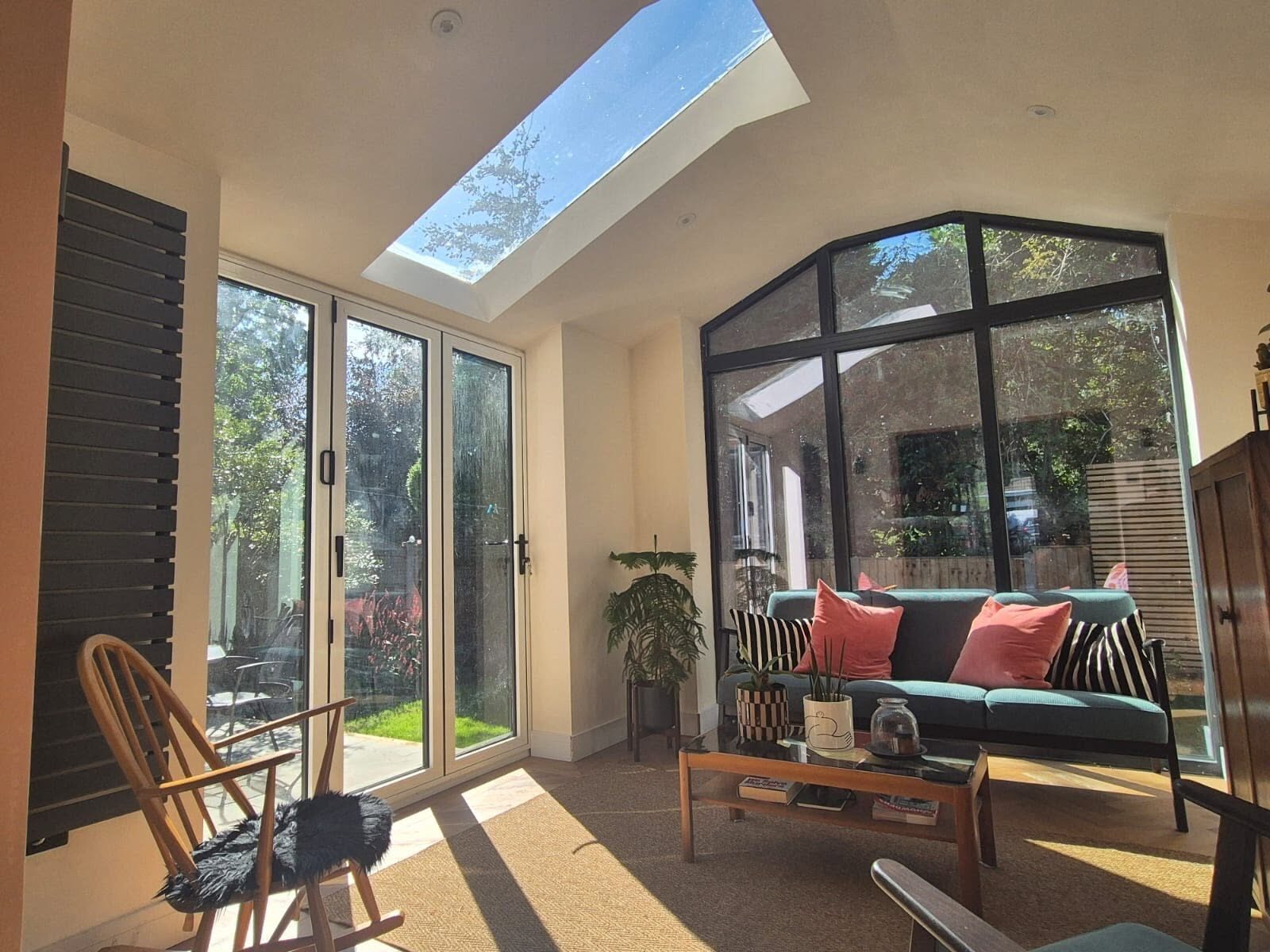 Interior of an extension with anthracite bi-fold doors and a roof lantern
