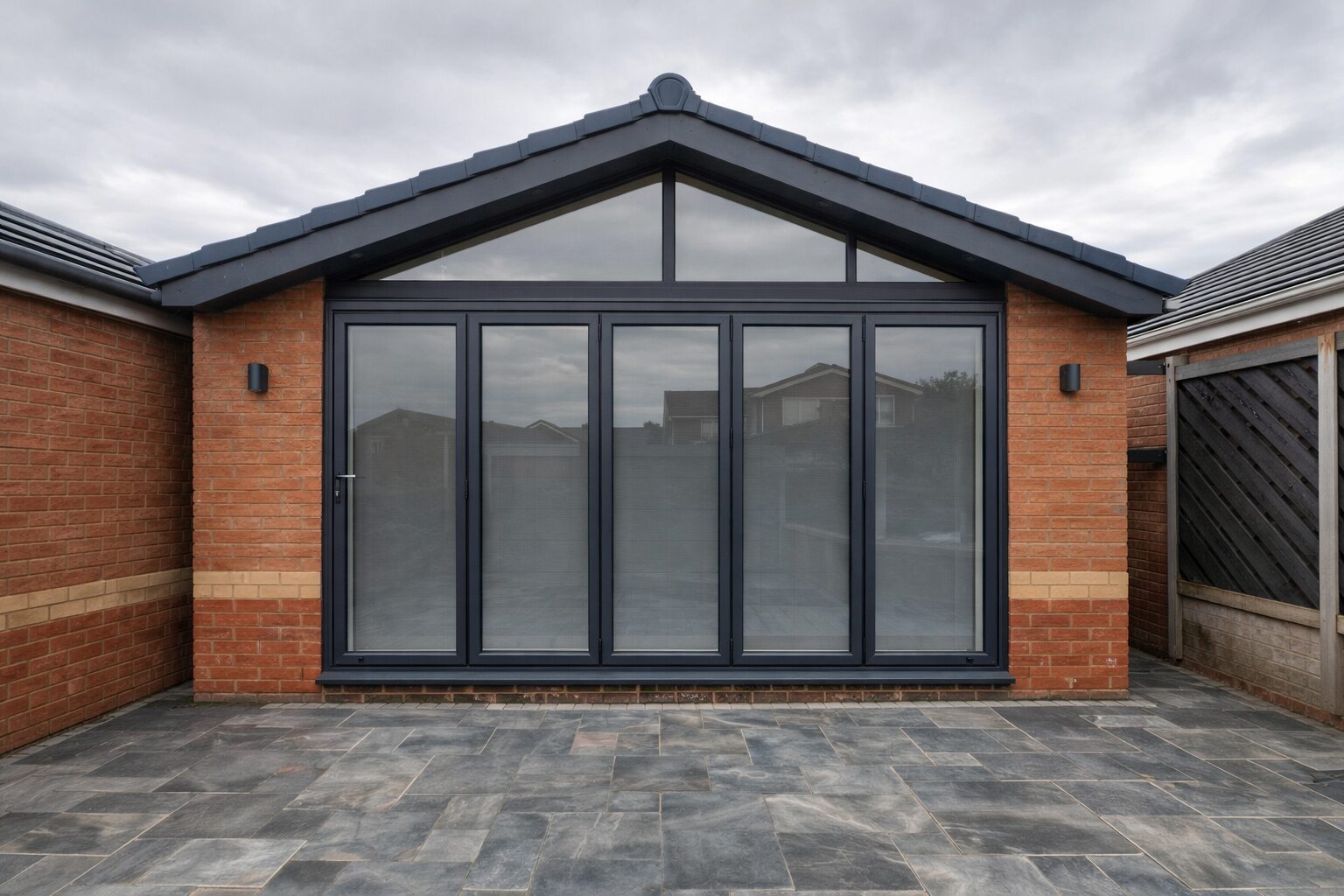 Anthracite bi-fold doors on a brick extension