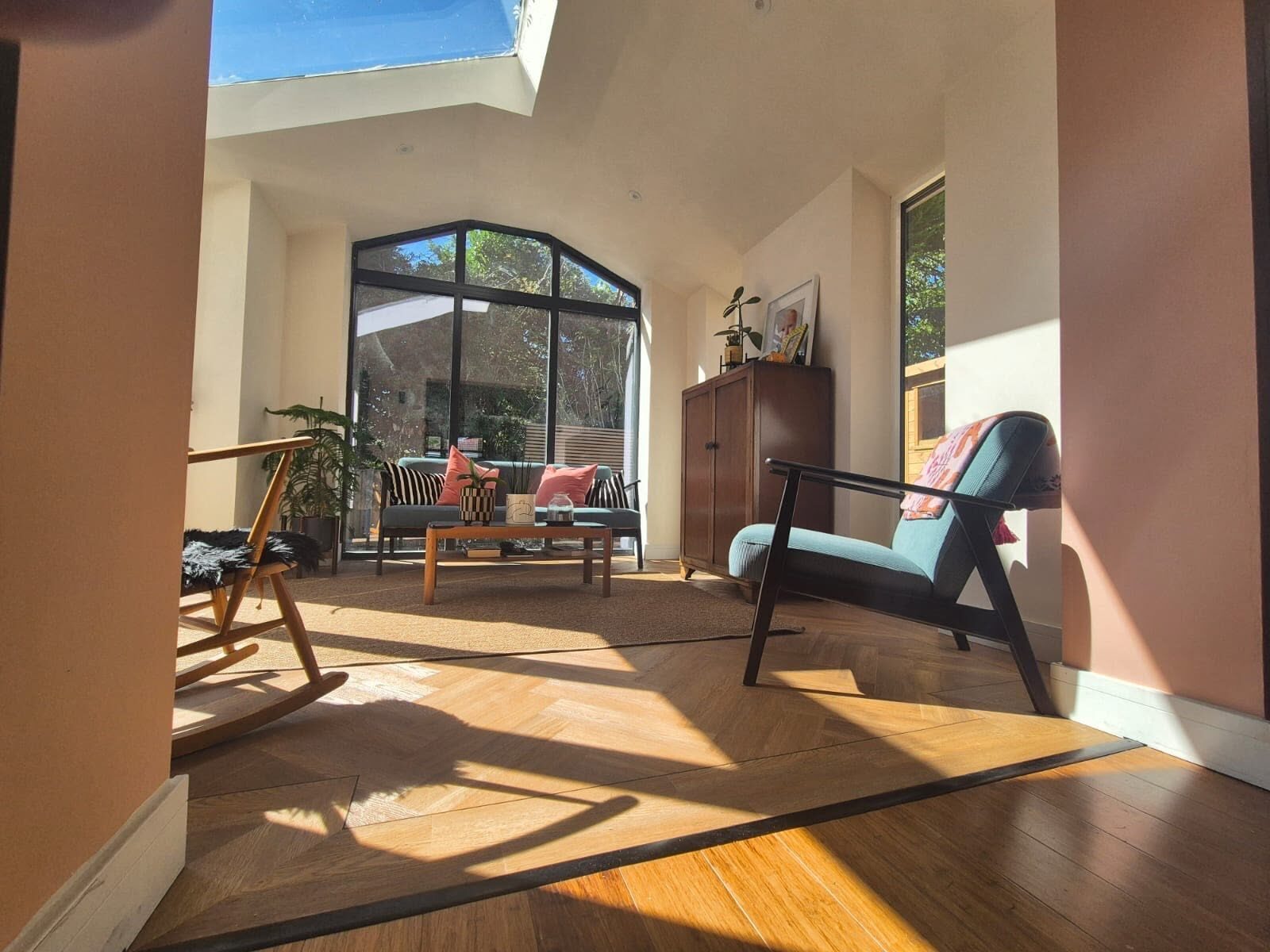 Bright conservatory interior with an arched window and tiled floor