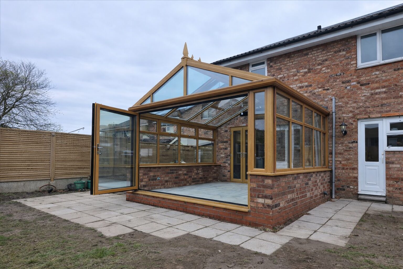 Oak-effect conservatory with a gable roof