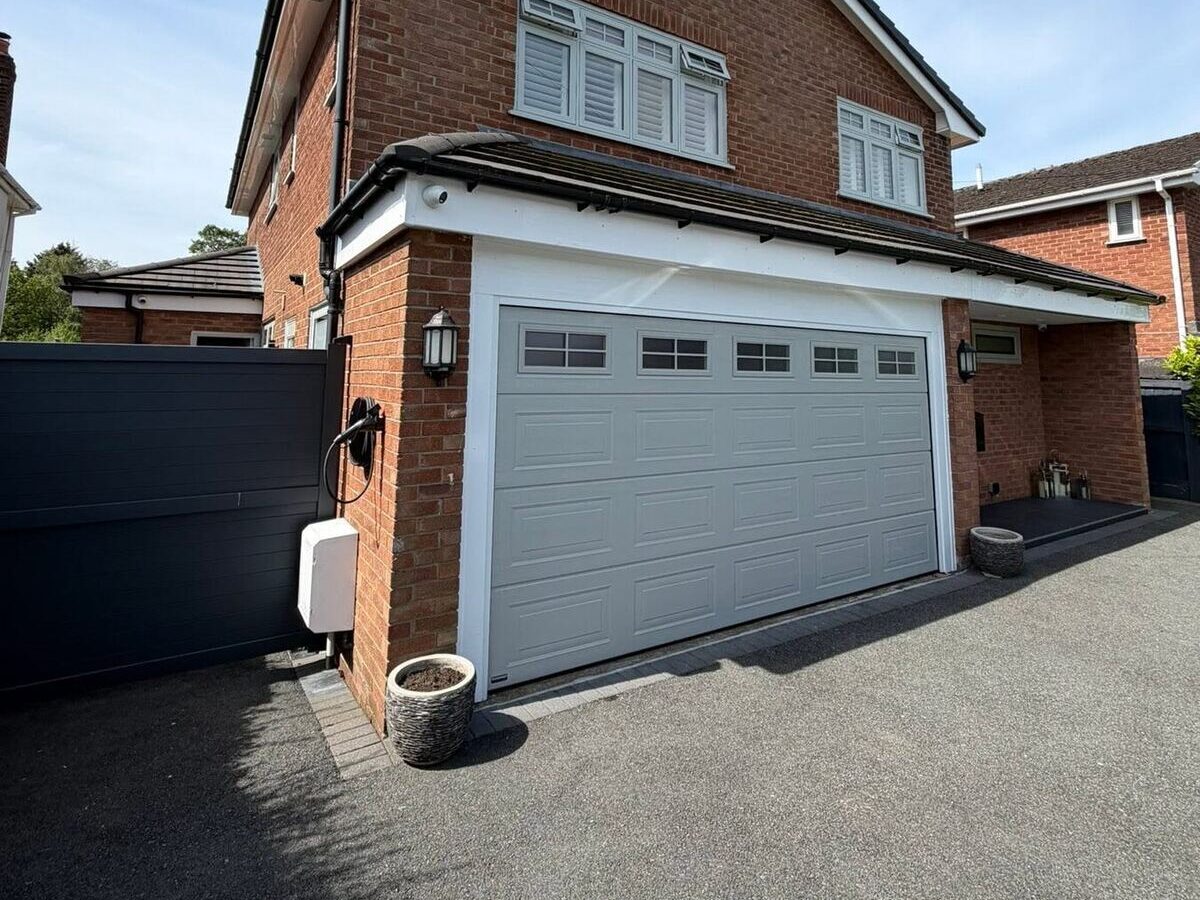 Detached house with a white sectional garage door