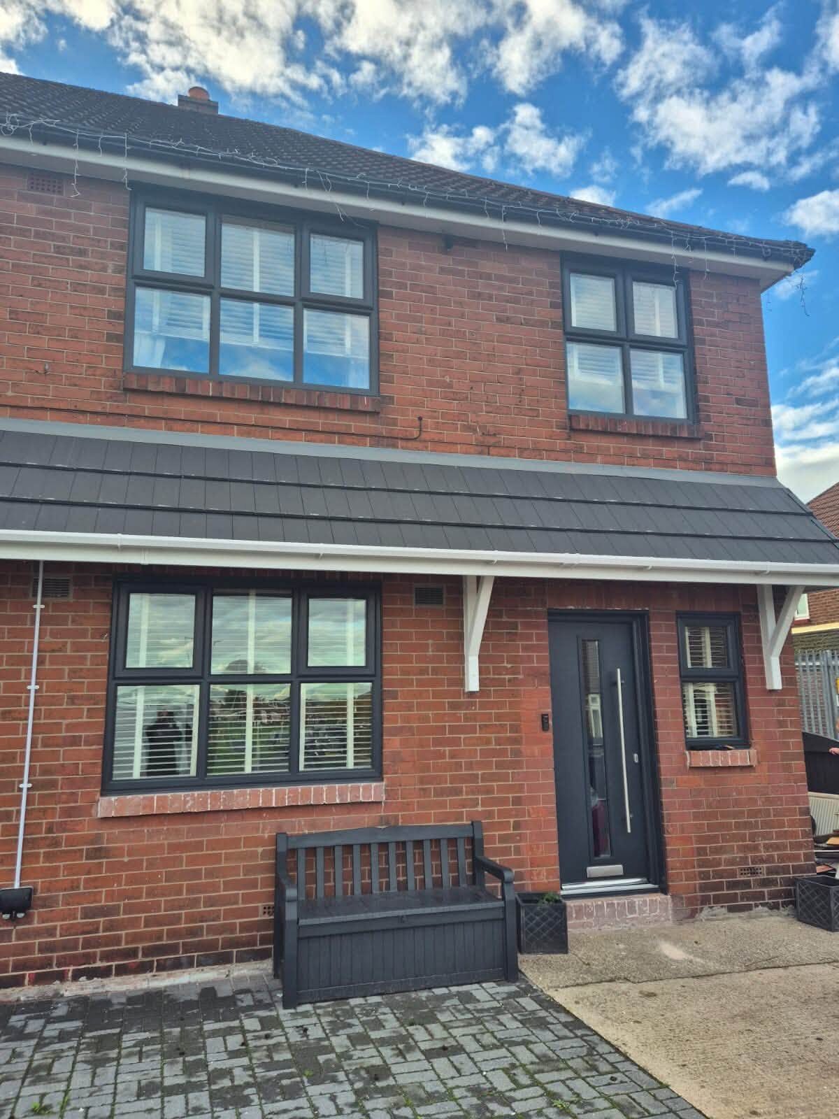 Semi-detached house with white fascias and grey windows