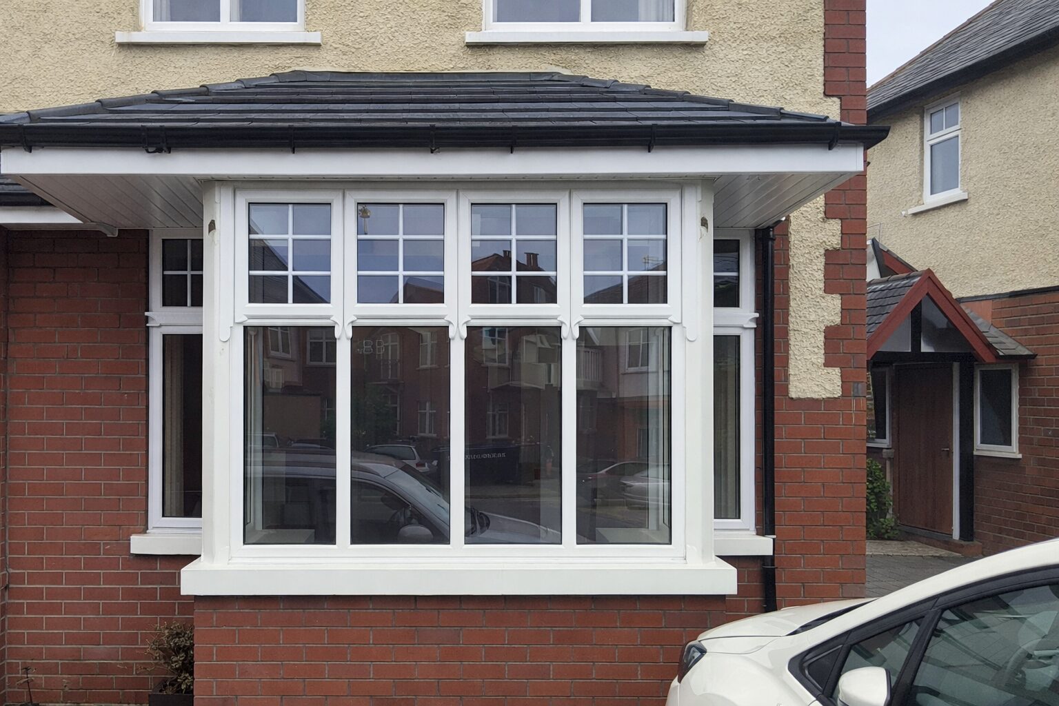 White uPVC bay window on a red brick house