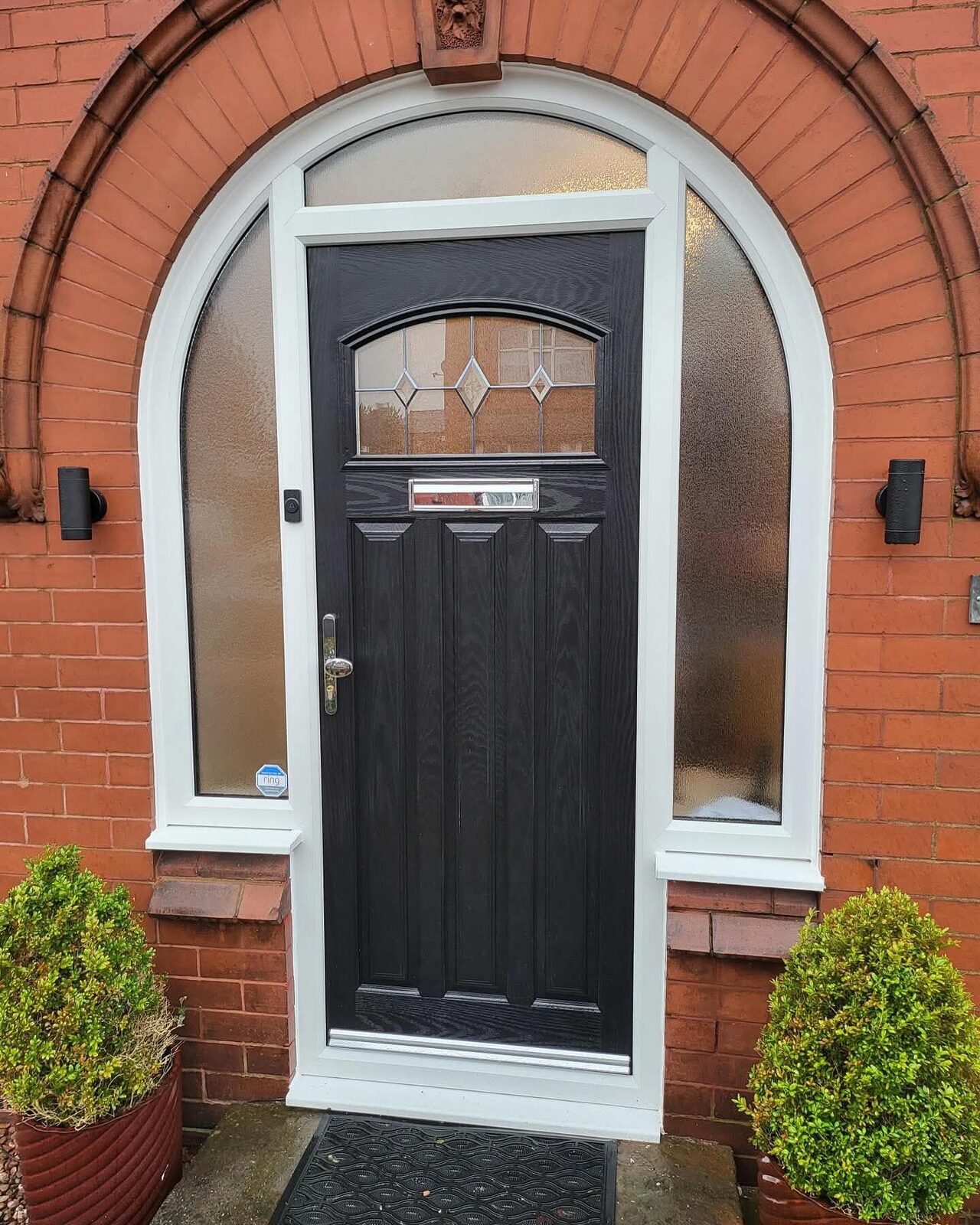 Black front door with a leaded arched fanlight